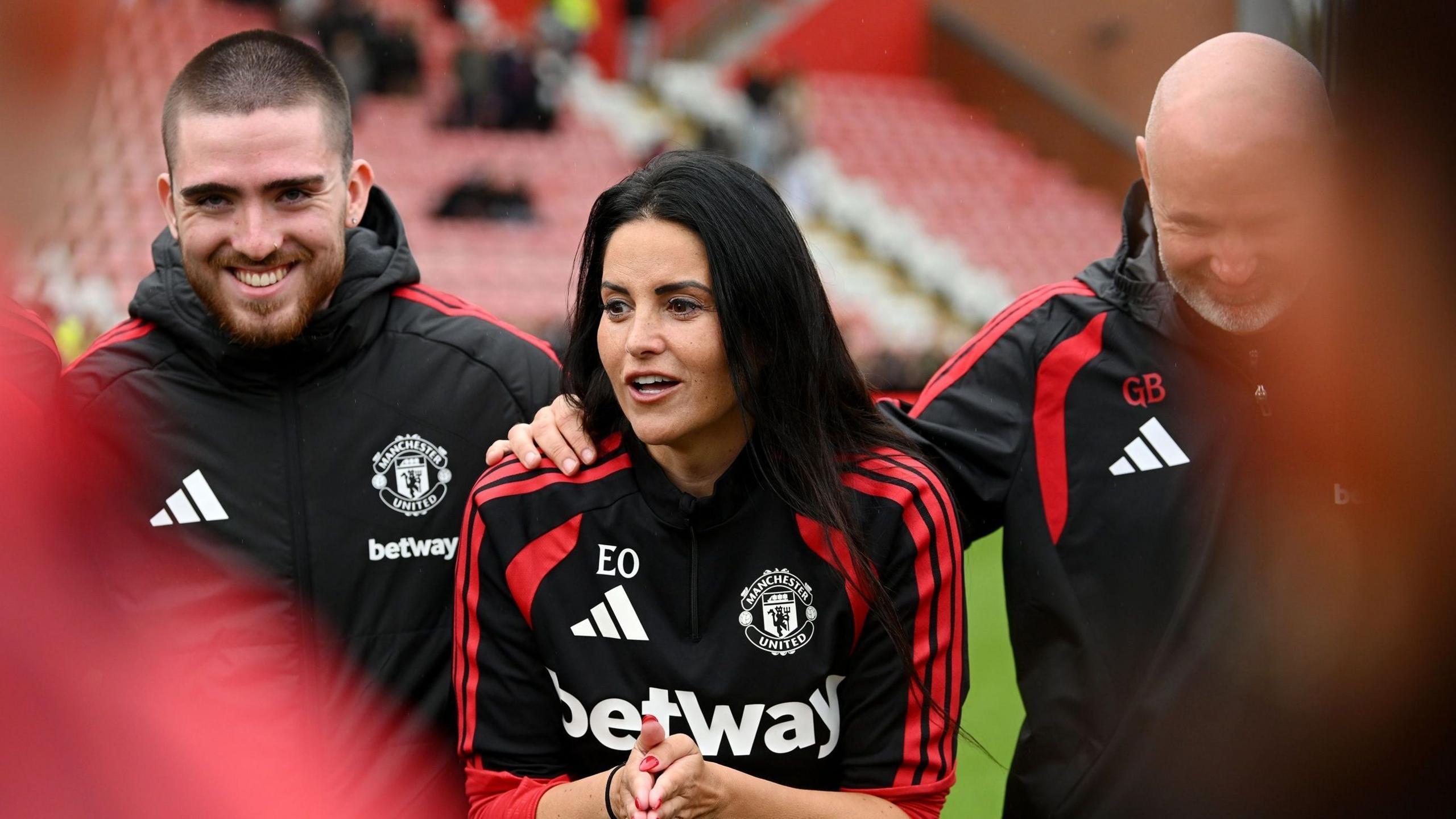 Eva Olid stands in a circle at the end of a Manchester United match