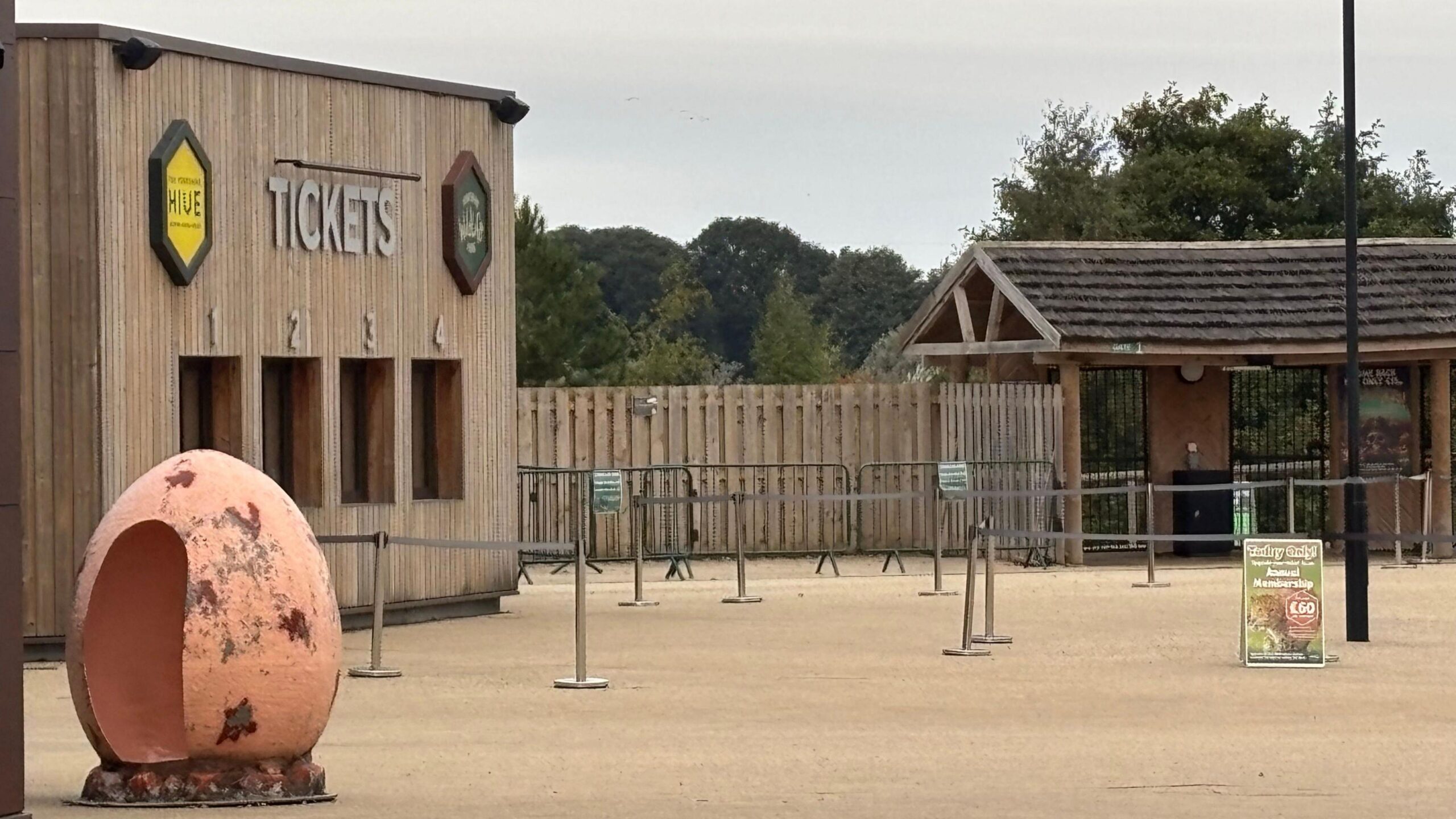 Ticket desks at the entrance to Yorkshire Widlife Park - a wooden building with barriers in front