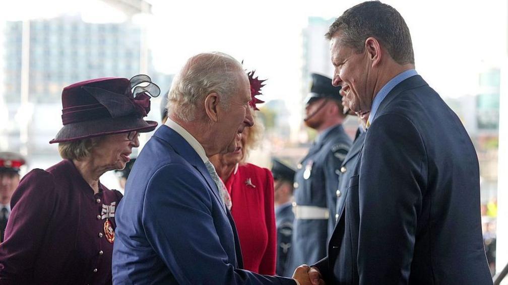 The King and Rhun ap Iorwerth shaking hands near the Senedd entrance