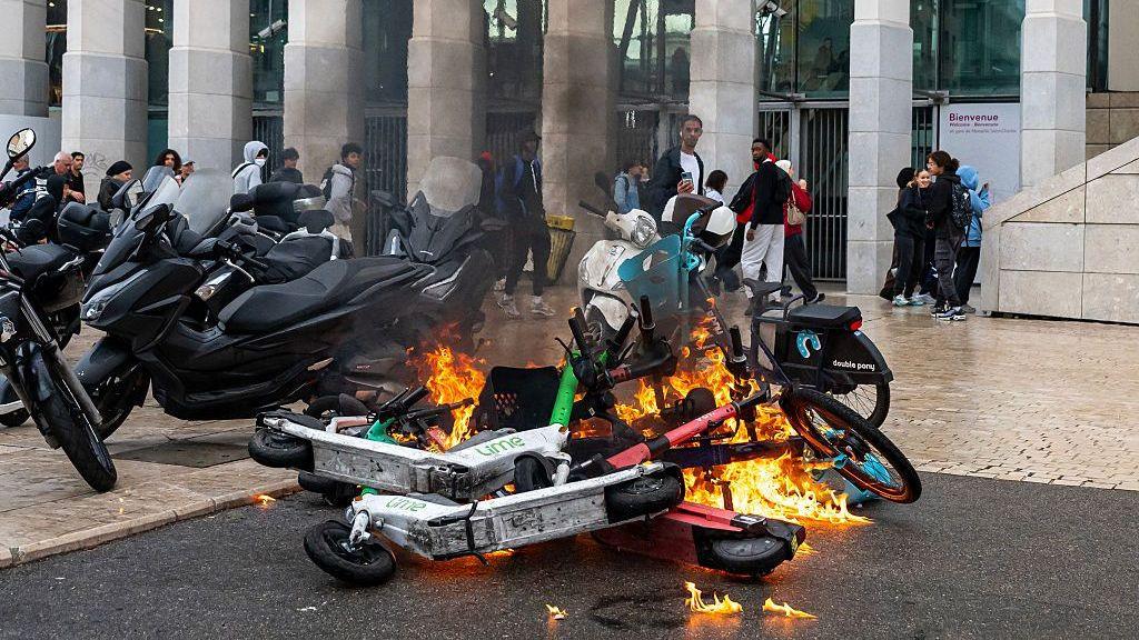 This photograph shows burning e-scooters near the Saint-Charles secondary school amid high school and student protests, in Marseille, southern France, on October 1, 2026.