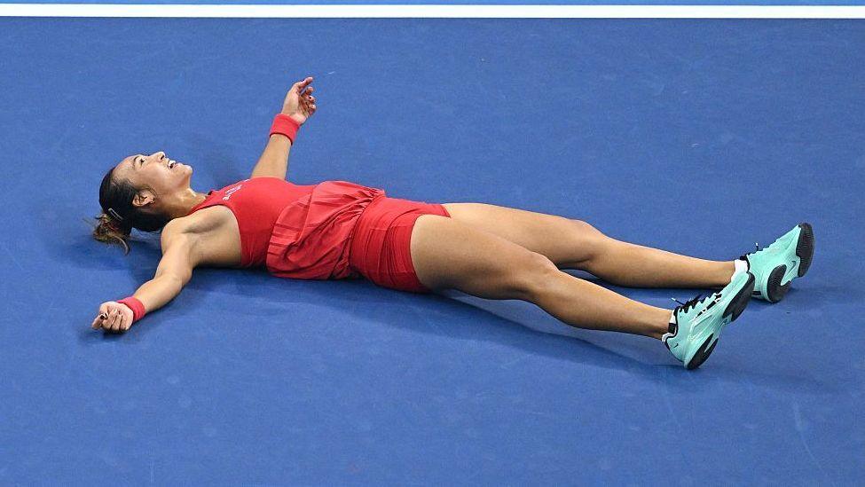 Zheng Qinwen collapses on the court in celebration