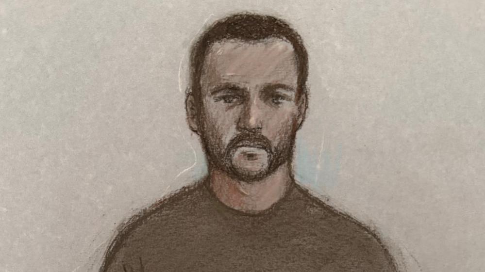 Court sketch of Teddy Young in court. He has short black hair and a black beard and is wearing a grey-ish sweartshirt