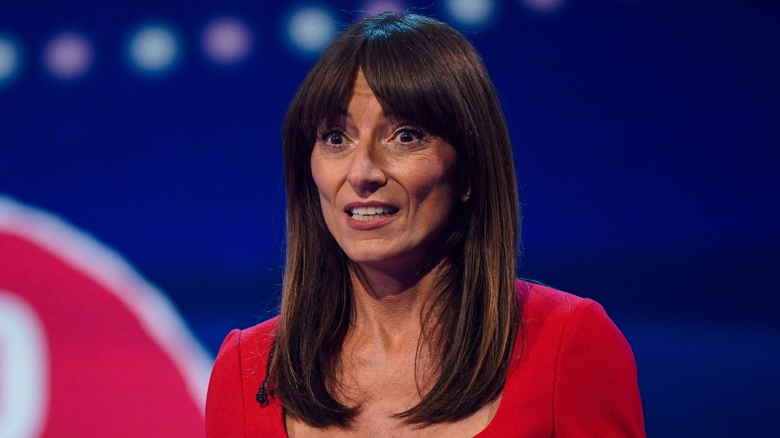 Davina McCall wearing a red outfit while hosting Red Nose Day in 2025