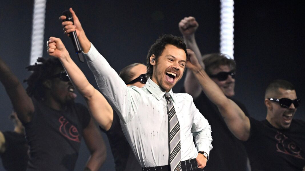 Brit Awards boosted Manchester economy by £5m, study finds Harry Styles performs at the Brit Awards. He is wearing a grey office shirt and tie combination.