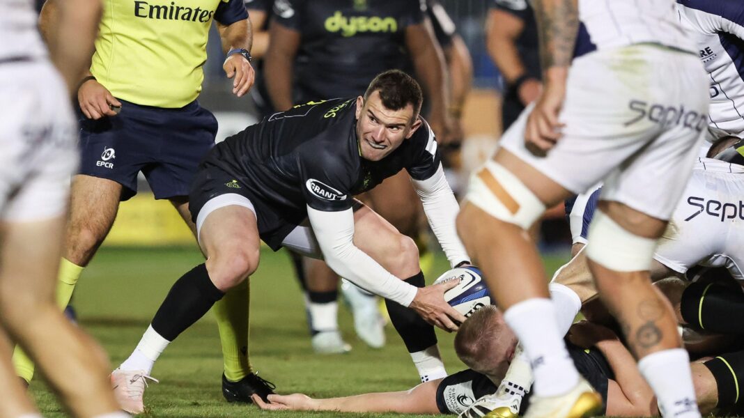 Du Preez faces long spell out but ‘magic’ Green impresses Ben Spencer crouches forward and holds a rugby ball in two hands as he picks it up off the floor during Bath v Montpellier. He is looking to his right and wearing black Bath kit