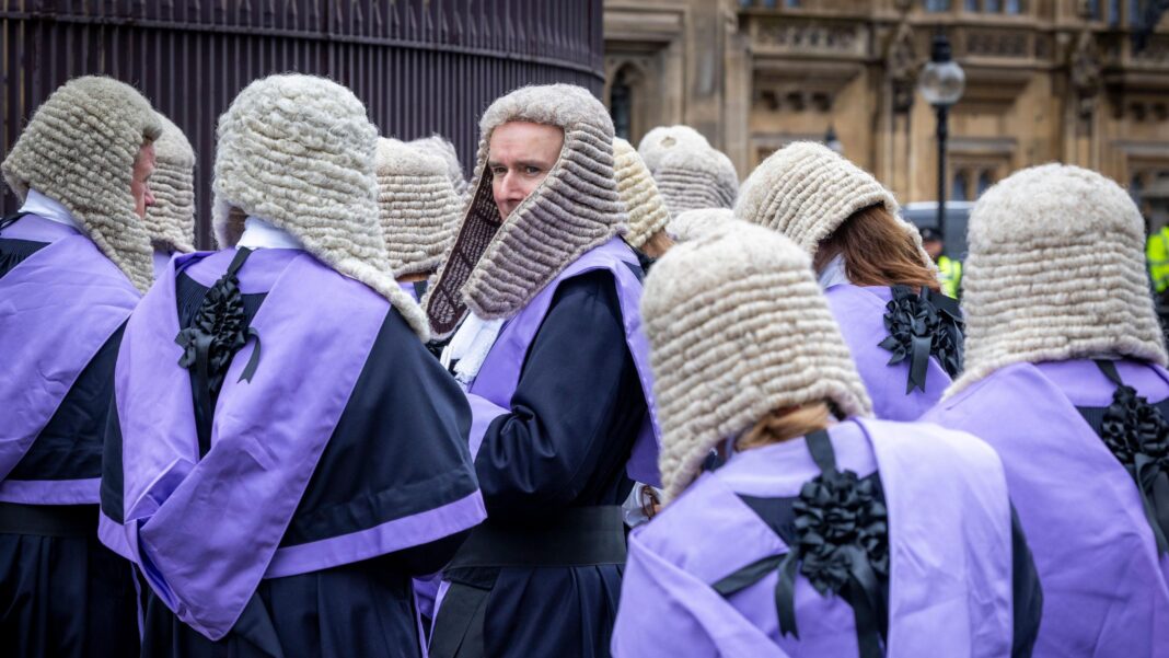 Courts backlog will fall despite scrapping of jury trial plan, minister says Rear view of judges and KCs in wigs and gowns
