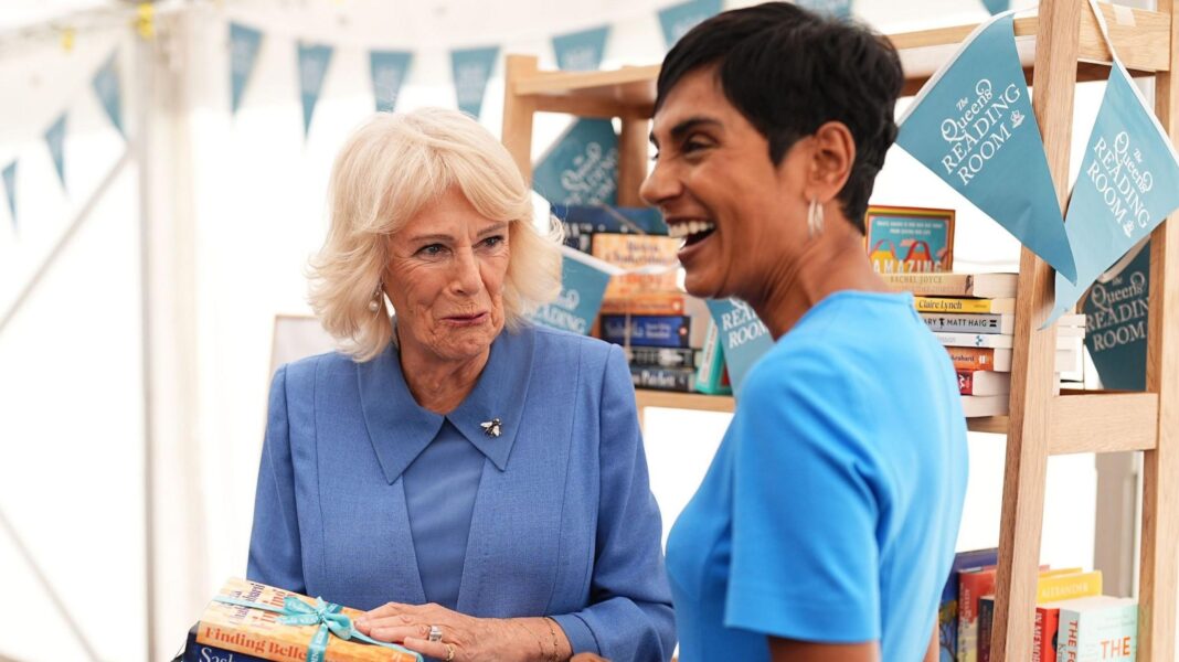 Queen reflects on reading ‘forbidden’ Lady Chatterley’s Lover under the pillow Queen Camilla holding a set of books, standing beside Reeta Chakrabarti