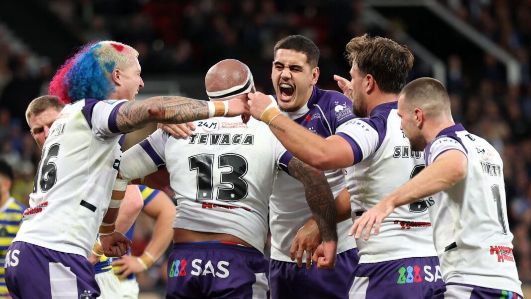 Wakefield players congratulate Jazz Tevaga (13) after his try against Warrington