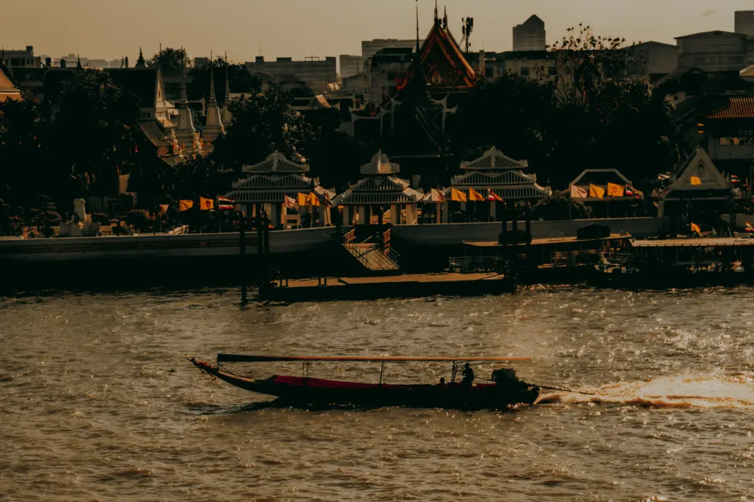 The Tremendous Revival of Bangkok’s Chao Phraya Waterfront Traditional long tail boat gliding along the chao phraya river